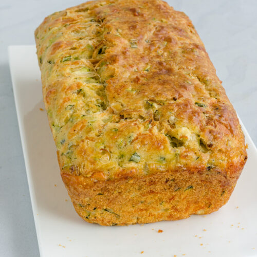 Zucchini Bread on a White plate on White Background Vertical Photo