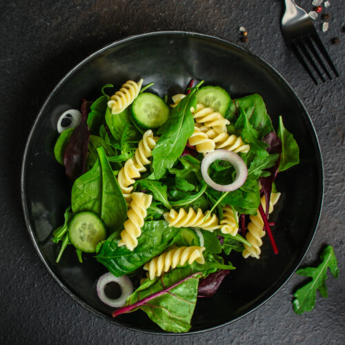 pasta salad Fusilli (leaves Lettuce, Spinach, Vegetables, Gemelli) Menu Concept. food background. copy space. Top view